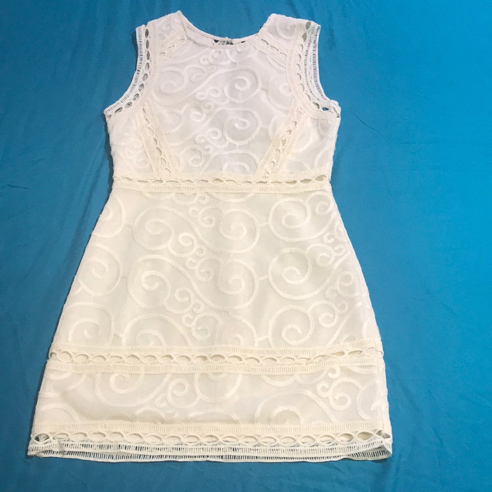 Cream dress with back cutout.